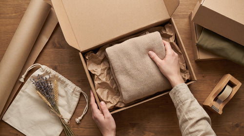 Sustainable packaging prepared with care on a table, representing turning brand values into customer retention.